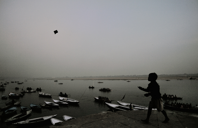 Boy flying Kite on the Ganges Benaras, India, 2009