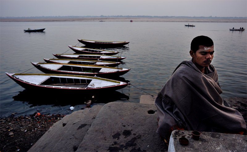 A man meditating (Dhyan) on the ghats of the river Ganges in Benaras.