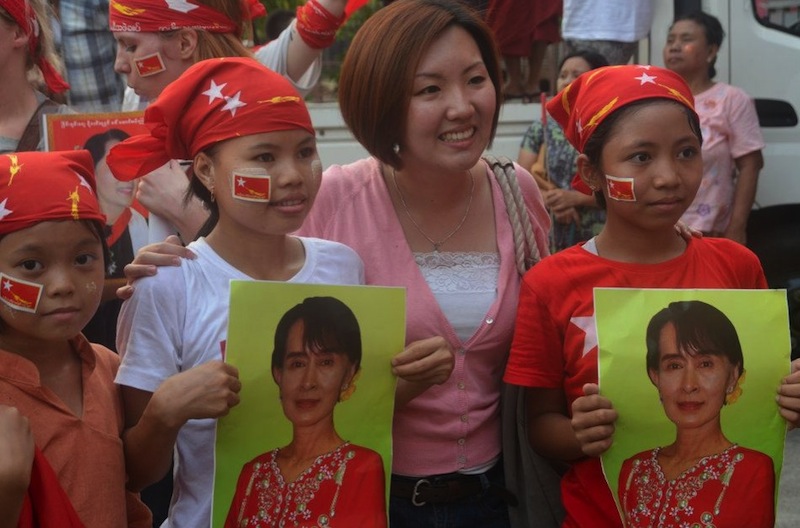 Young NLD supporters and their mother pose for a press photo on polling day in Rangoon