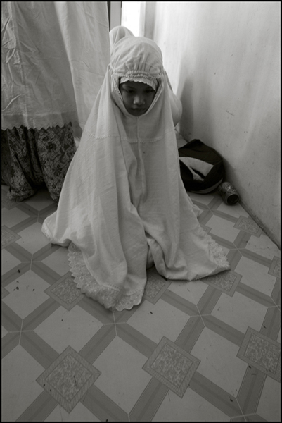 A girl during the midday prayer at an orphanage in Banda Aceh Indonesia