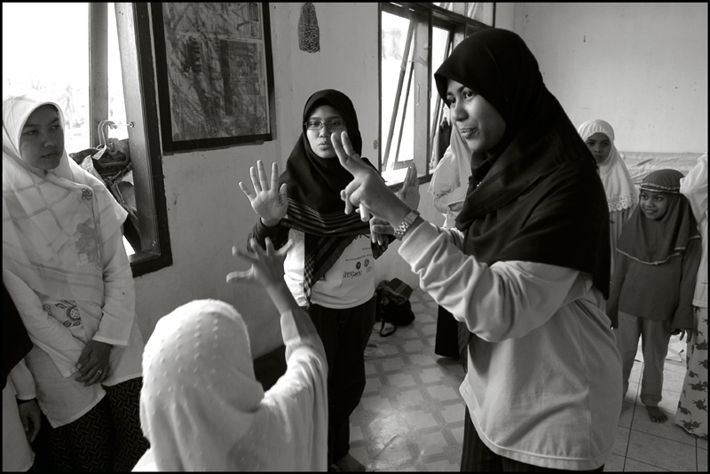 Students of the Fajar Hidayah organization play a game with girls at an orphanage in Banda Aceh Indonesia