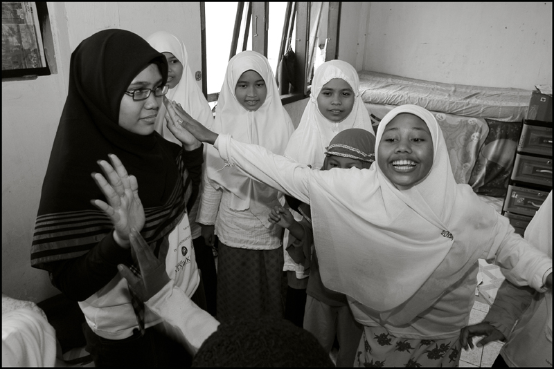 Students of the Fajar Hidayah organization play a game with the girls at an orphanage in Banda Aceh Indonesia