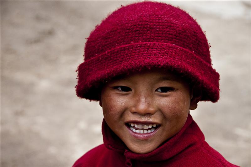 A portrait of a young monk that enjoys a moment.