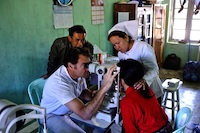 Dr James Muecke testing out new donated equipment at Hakha Eye Centre