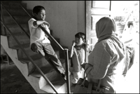 Two boys talk to a woman at an orphanage in Banda Aceh Indonesia