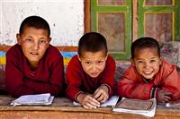 Three monks in the monastic school enjoy a moment in Upper Mustang