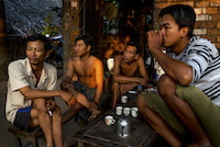 Shipyard workers drink tea before the day's work begins