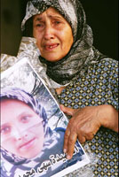 Mother holding a picture of her killed daughter, Marwaheen, Lebanon